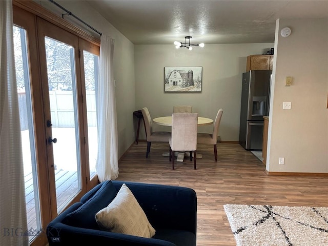 dining room with a chandelier and light hardwood / wood-style floors