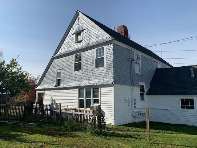 rear view of property with a yard