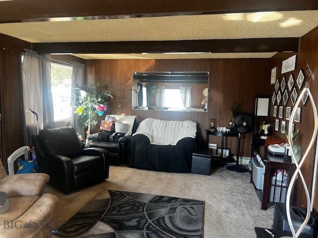 living room with carpet floors, wood walls, and beam ceiling