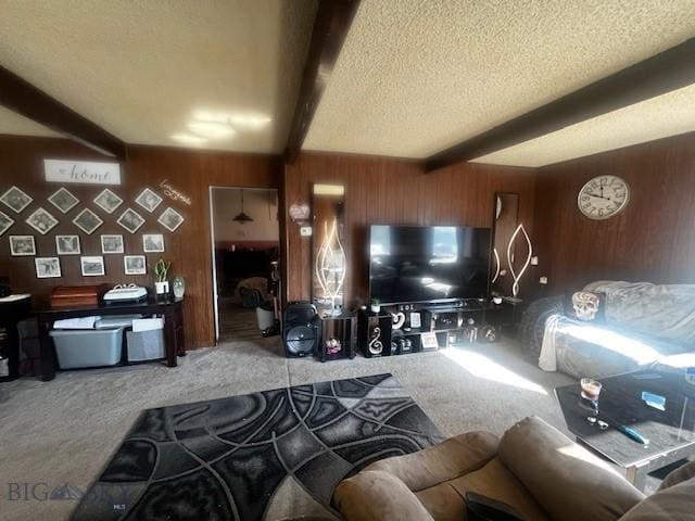 carpeted living area with wood walls, beam ceiling, and a textured ceiling
