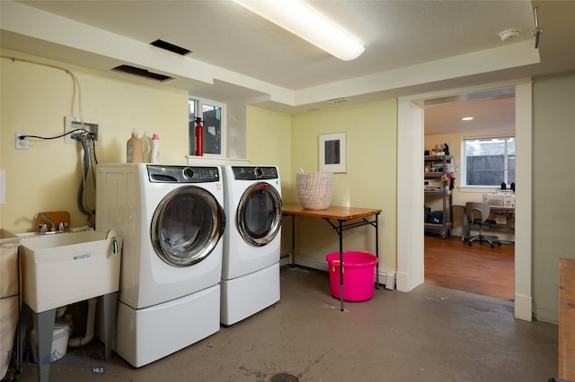 clothes washing area featuring separate washer and dryer