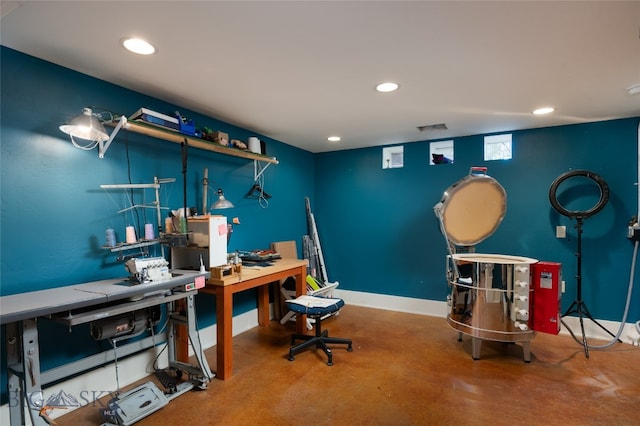 office area with a workshop area and concrete floors