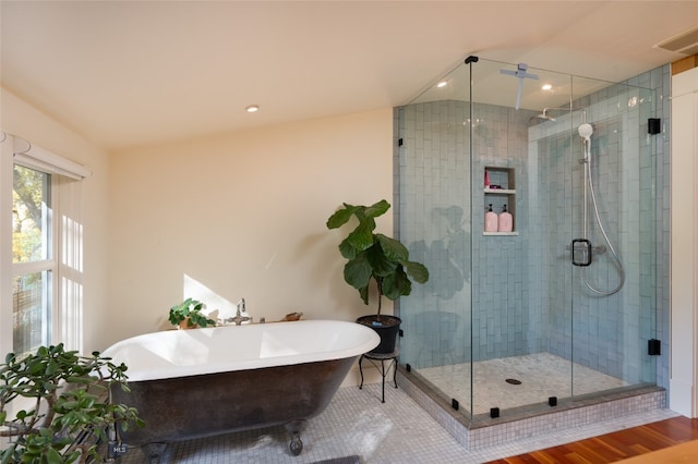 bathroom with plus walk in shower and hardwood / wood-style floors