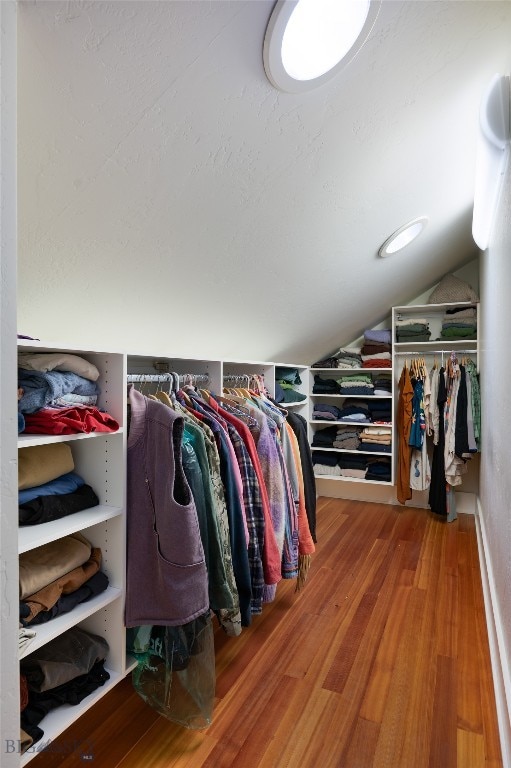 walk in closet featuring lofted ceiling and hardwood / wood-style floors