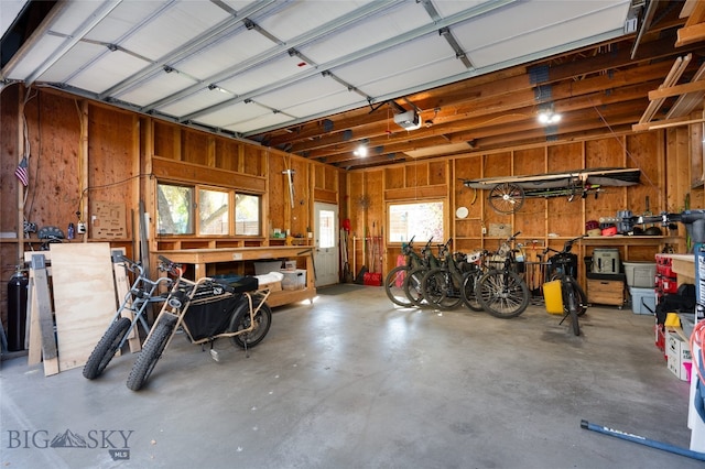 garage featuring wood walls and a workshop area