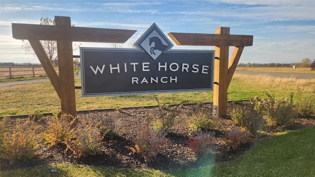 community / neighborhood sign with a rural view