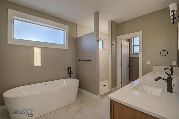 bathroom featuring vanity, plenty of natural light, and shower with separate bathtub