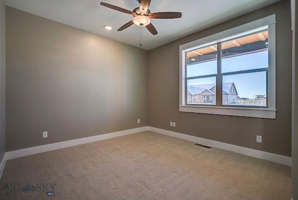 carpeted empty room featuring ceiling fan