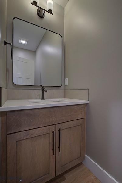 bathroom with vanity and hardwood / wood-style floors