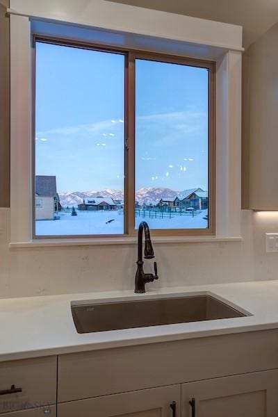 kitchen featuring a mountain view and sink