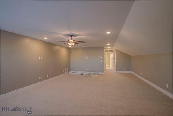 additional living space with light carpet, vaulted ceiling, and ceiling fan