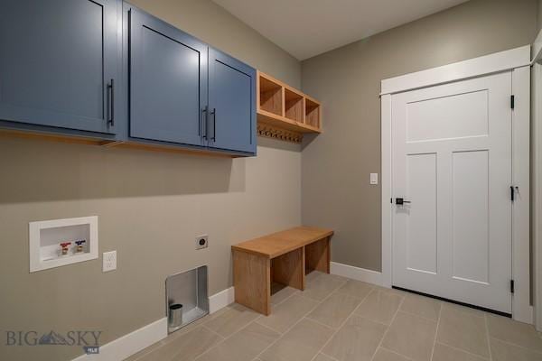 clothes washing area featuring electric dryer hookup, washer hookup, and cabinets