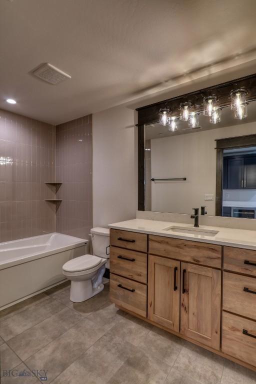 119 Clancy Way, Bozeman, MT 59718 - bathroom with toilet, vanity, shower / bathtub combination, and tile patterned floors