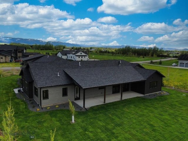 119 Clancy Way, Bozeman, MT 59718 - back of house with a patio area, roof with shingles, a yard, and a mountain view