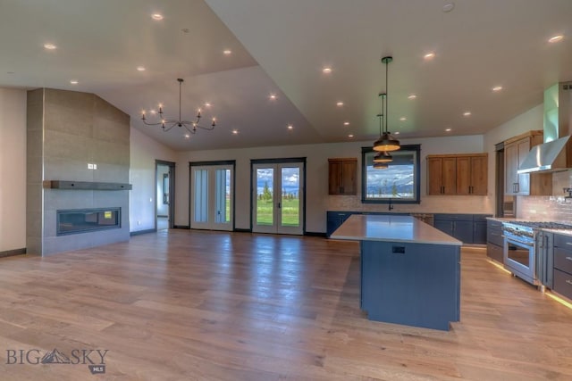 119 Clancy Way, Bozeman, MT 59718 - kitchen with open floor plan, wall chimney exhaust hood, a center island, a chandelier, and recessed lighting