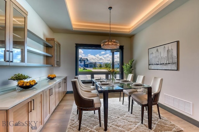 119 Clancy Way, Bozeman, MT 59718 - dining room with light wood-style floors, a tray ceiling, baseboards, and a chandelier