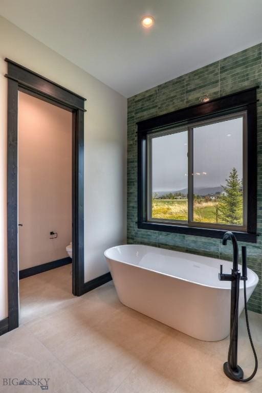 119 Clancy Way, Bozeman, MT 59718 - bathroom with a freestanding bath, recessed lighting, baseboards, and toilet
