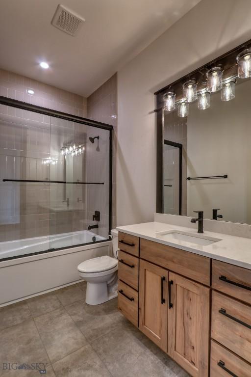 119 Clancy Way, Bozeman, MT 59718 - bathroom featuring toilet, enclosed tub / shower combo, and vanity