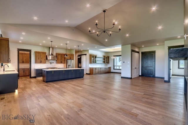 119 Clancy Way, Bozeman, MT 59718 - unfurnished living room with a sink, healthy amount of natural light, a chandelier, light wood finished floors, and recessed lighting