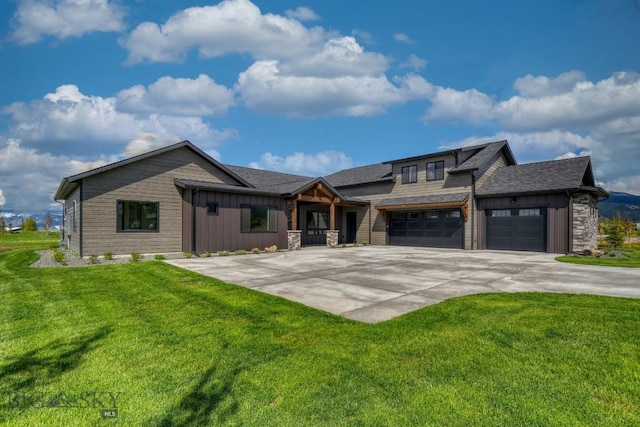 119 Clancy Way, Bozeman, MT 59718 - view of front of home featuring board and batten siding, a front lawn, concrete driveway, an attached garage, and a shingled roof