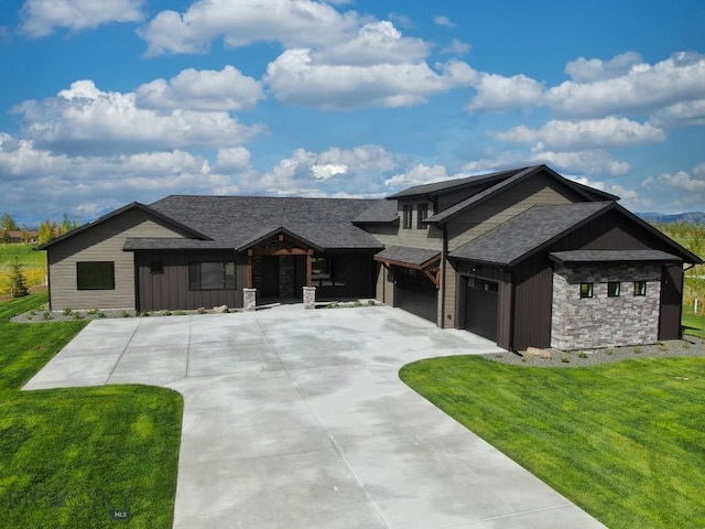 119 Clancy Way, Bozeman, MT 59718 - view of front of home featuring board and batten siding, a front yard, driveway, roof with shingles, and an attached garage