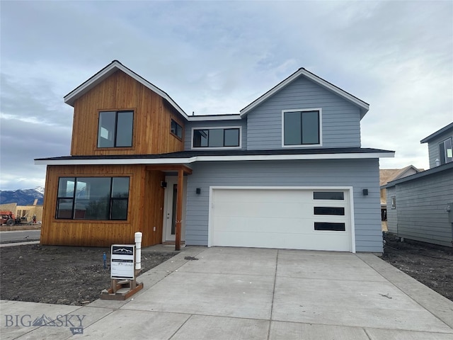 view of front facade with a mountain view and a garage