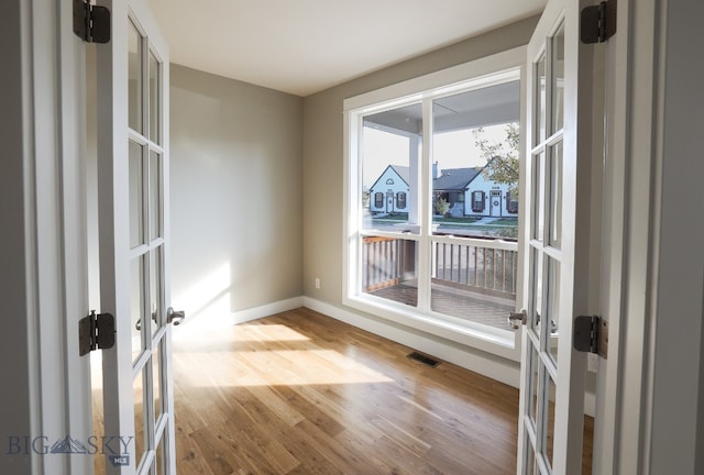 spare room featuring french doors and wood-type flooring