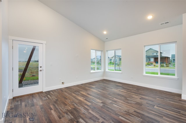 spare room with high vaulted ceiling and dark hardwood / wood-style flooring