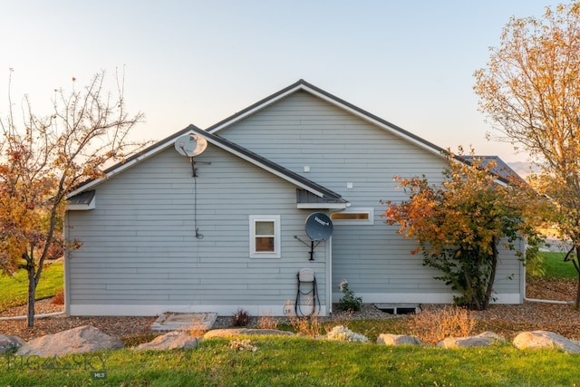 view of back house at dusk