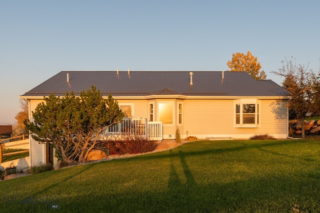 rear view of property featuring a yard