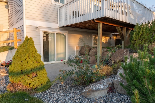 rear view of property featuring a patio area and a deck