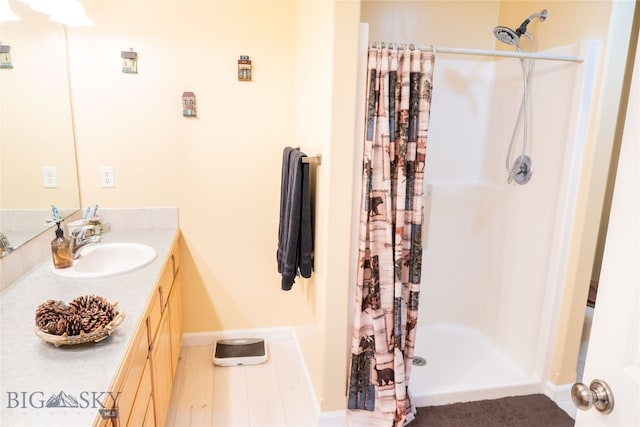 bathroom featuring vanity and curtained shower