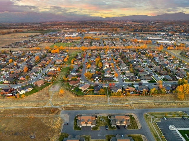 aerial view at dusk featuring a mountain view