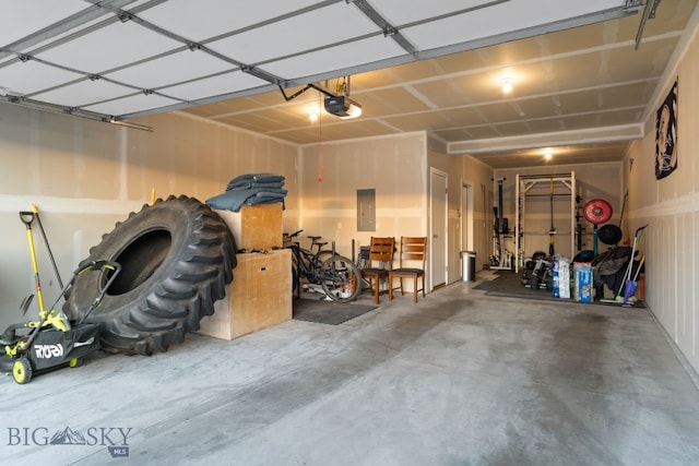 garage featuring a garage door opener and electric panel