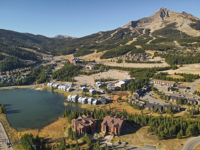 drone / aerial view featuring a water and mountain view