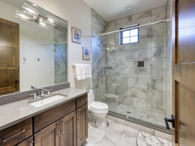 bathroom featuring a shower with door, toilet, and vanity