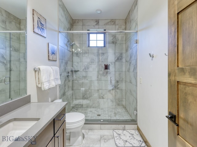 bathroom with toilet, vanity, and a shower with door