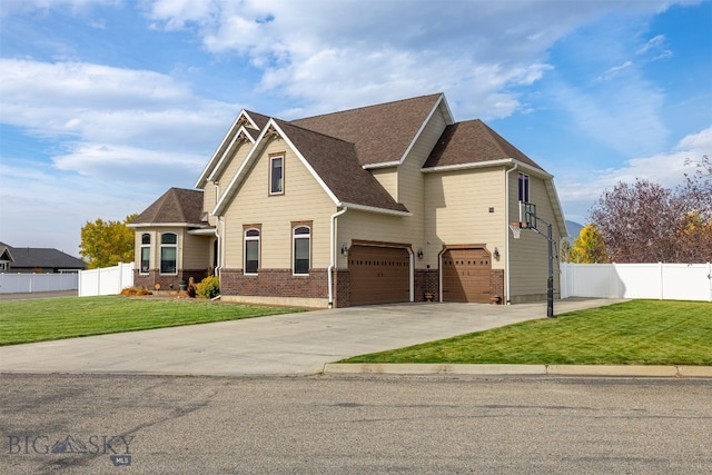 view of front of house with a garage and a front lawn