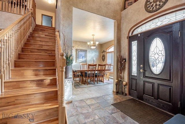 foyer entrance featuring an inviting chandelier