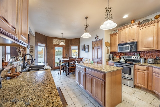 kitchen with electric range, light stone counters, a center island, pendant lighting, and sink