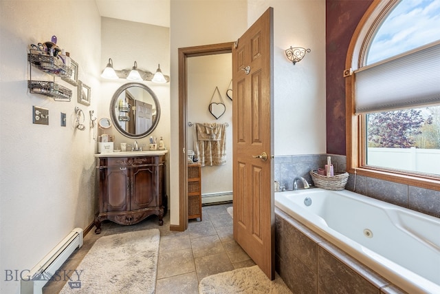 bathroom featuring vanity, tile patterned floors, a baseboard heating unit, and tiled tub