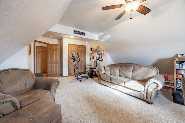 carpeted living room featuring ceiling fan, a textured ceiling, and lofted ceiling