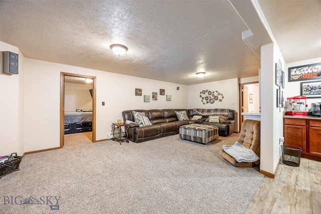 living room featuring a textured ceiling and light wood-type flooring