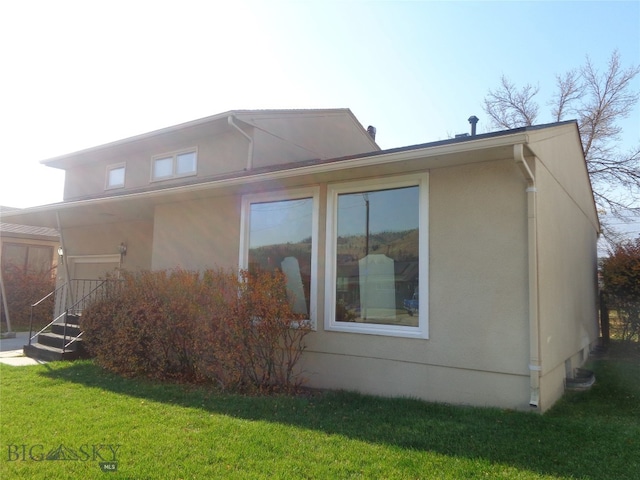 view of property exterior with a yard