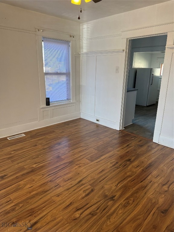 spare room with ceiling fan and dark hardwood / wood-style flooring