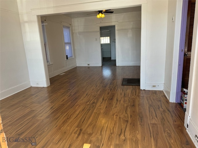 spare room with dark wood-type flooring and ceiling fan