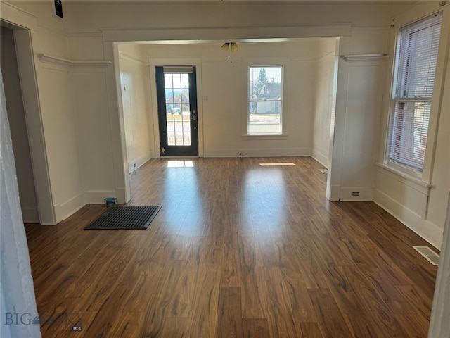 empty room with ceiling fan and dark hardwood / wood-style floors