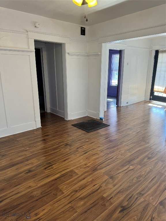 empty room featuring ceiling fan and dark hardwood / wood-style flooring