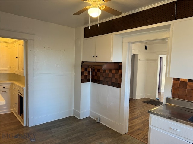 kitchen with dark wood-type flooring, backsplash, ceiling fan, and white cabinets