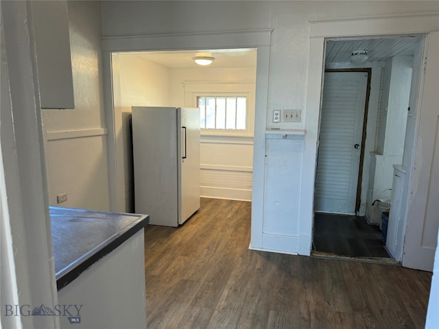 corridor with dark hardwood / wood-style flooring